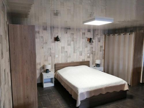 - une chambre avec un lit blanc et 2 tables de chevet dans l'établissement Ideal pour un couple a la recherche du calme, à Frontignan