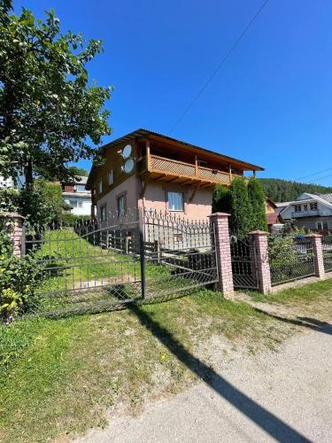 a house with a fence in front of it at Svitlyachok in Yaremche
