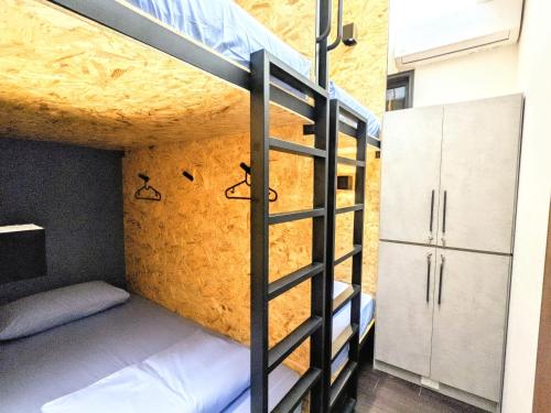 a bunk bed in a room with a ladder at N JOY TAKAO in Kaohsiung