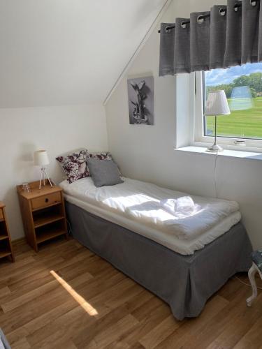 a bed in a room with a window at Halmstad Tönnersjö Golf in Eldsberga