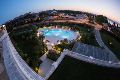 an aerial view of a swimming pool at night at Palace Hotel Desenzano in Desenzano del Garda