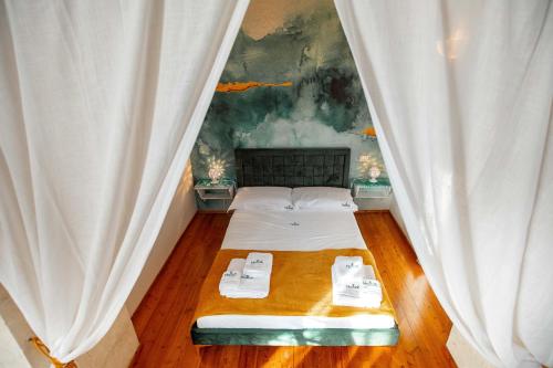 een slaapkamer met een bed met witte gordijnen bij Hostunia in Ostuni