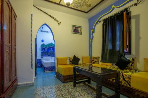 a living room with a couch and a table at Casa El Mrabet in Chefchaouene