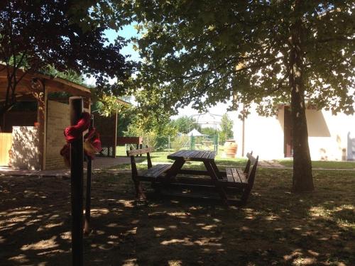 a picnic table and a bench under a tree at Agriturismo San Michele in San Michele