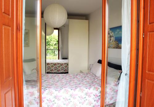 a bedroom with a mirror with a bed in it at Appartemento Stella in Bergamo