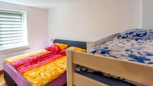 a bedroom with two bunk beds with colorful sheets at Gäste- & Ferienwohnungen in Sonderhausen Güntherstraße 25 in Sondershausen