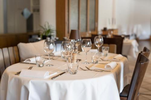 a table with wine glasses and napkins on it at Hotel Restaurant Sternen in Gelfingen