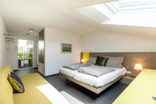 a bedroom with a bed and a skylight at Hotel Restaurant Sternen in Gelfingen