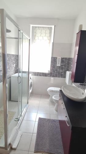 a bathroom with a sink and a toilet and a shower at B&B Regina in Busto Arsizio