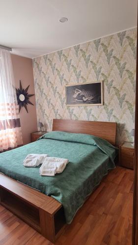a bedroom with a bed with two towels on it at B&B Regina in Busto Arsizio