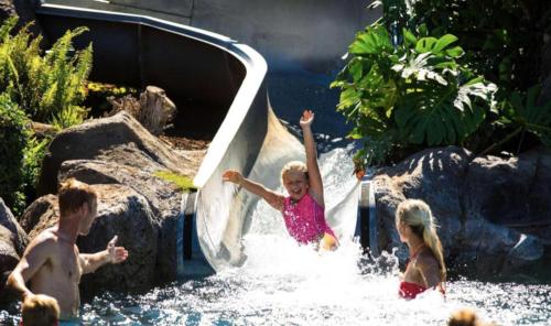 a little girl sliding down a slide in the water at 2 Bedroom OCEAN VIEW LUXURY resort condo with extra large balcony in Lahaina