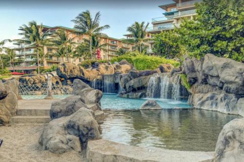 a waterfall in a pool in a resort at 2 Bedroom OCEAN VIEW LUXURY resort condo with extra large balcony in Lahaina