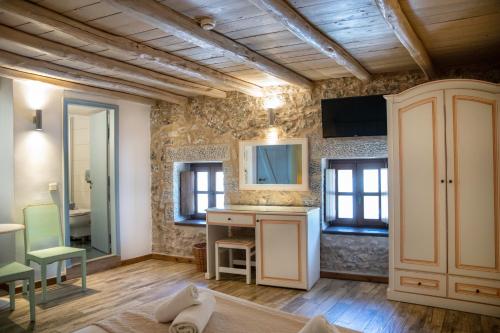 a bathroom with a vanity and a sink in a room at Trapela Areopolis, Boutique Hotel in Areopolis