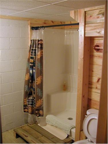 a bathroom with a shower curtain and a toilet at El Dorado Ranch in Custer