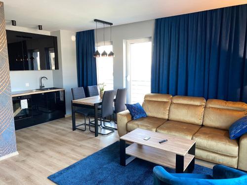 a living room with a couch and a table at VIP Apartament-Marine in Rumia