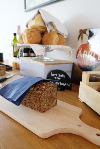 a loaf of bread sitting on top of a cutting board at Rörums Gårdshotell in Simrishamn