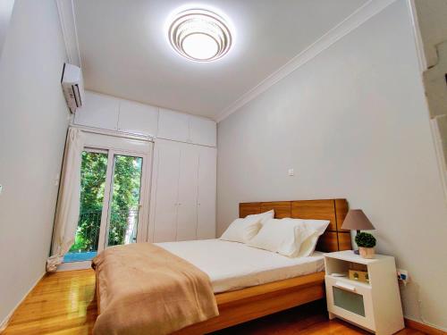 a bedroom with a bed and a window at WSD Brand Cozy 2BD with Balcony near Acropolis in Athens