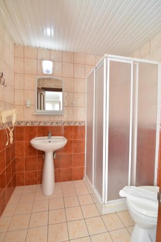 a bathroom with a shower and a sink and a toilet at Rose Garden Apart Hotel in Alanya