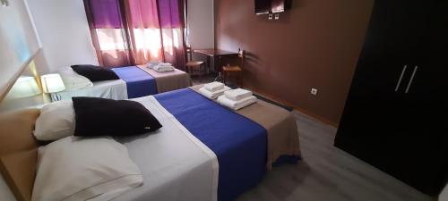 a hotel room with two beds with towels on them at Vale do Rodo in Peso da Régua