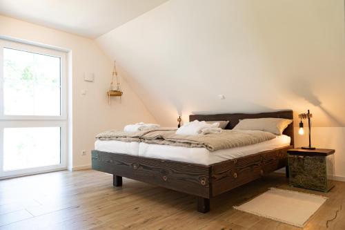 a bedroom with a bed in a room with a window at Ferienhaus Heuliebe in Herbstein