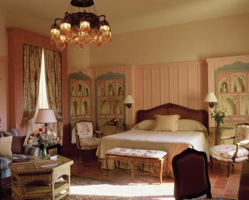 a bedroom with a bed and a chandelier at Albergo Hotel in Beirut