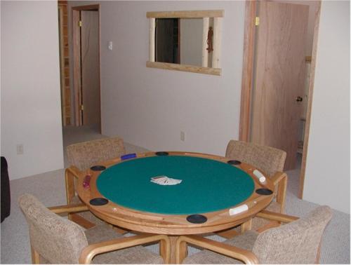 a wooden table with chairs around it in a room at Comanche Lodge in Custer