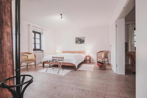 a bedroom with a bed and a table and chairs at Ferienwohnung Tausendfreund am Chiemsee in Breitbrunn am Chiemsee