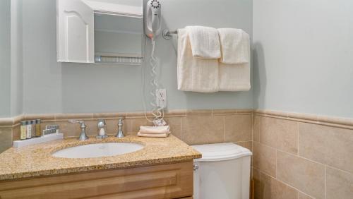 a bathroom with a sink and a toilet at The Cliffside Resort Condominiums in Greenport