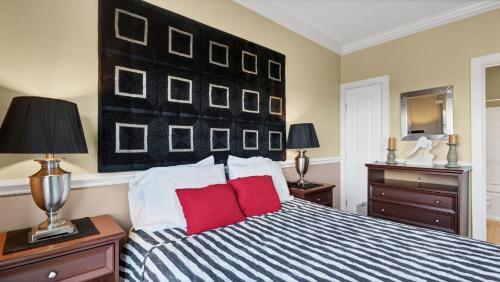 a bedroom with a blue and white bed with red pillows at The Cliffside Resort Condominiums in Greenport