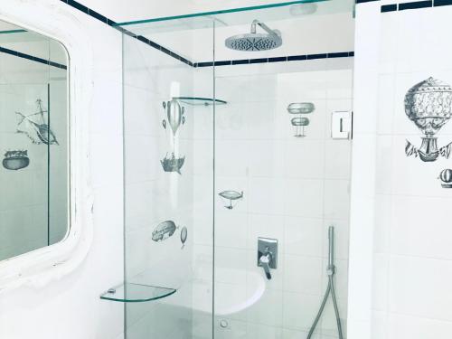 a glass shower in a bathroom withautical items on the wall at La Palladiana - Immobilevante in Ponza