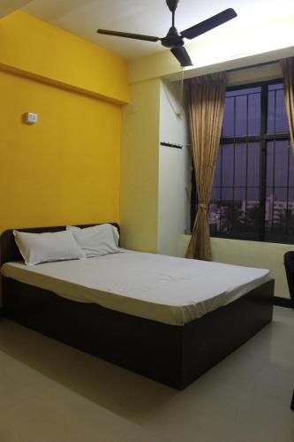 Krevet ili kreveti u jedinici u okviru objekta Aishvarya Residency Coimbatore