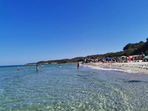a group of people in the water at a beach at Tenuta Turchi in Otranto