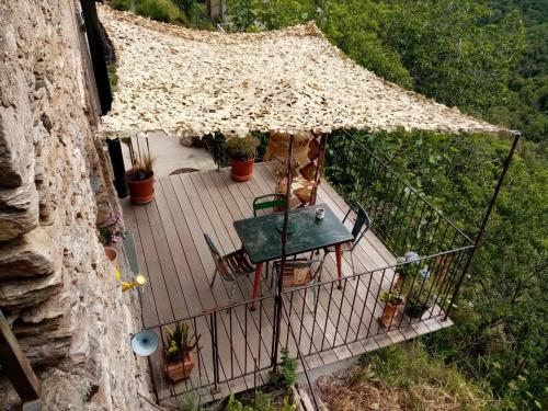 an aerial view of a deck with a table and chairs at Echo du Maquis in Penta-Acquatella