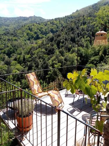 a balcony with chairs and a view of the mountains at Echo du Maquis in Penta-Acquatella