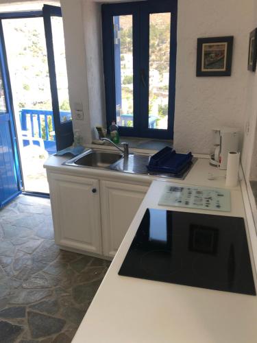 a kitchen with a sink and a counter top at Aegean Dream 3 in Agia Marina