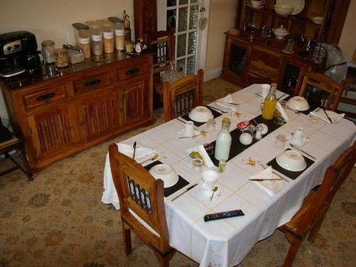 a dining room table with a white tablecloth on it at The Grange in Normanton