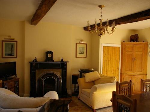 a living room with a couch and a fireplace at The Grange in Normanton