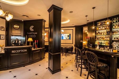 a bar in a restaurant with a counter and chairs at Boutique Guest House Coco in Plovdiv
