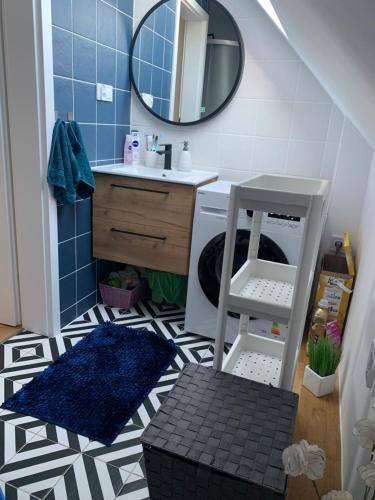 a small bathroom with a sink and a mirror at Słoneczne Wrota in Pisz