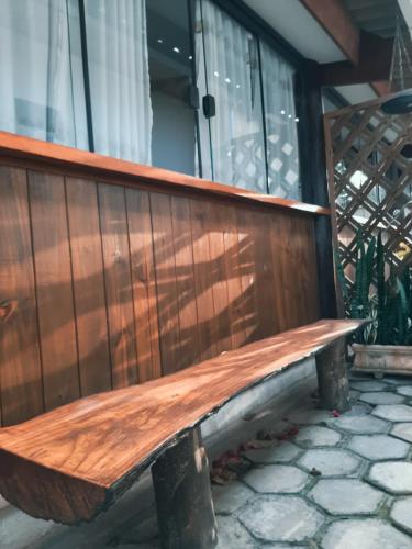 a wooden bench sitting on top of a porch at Pousada Ilha Sul in Cananéia