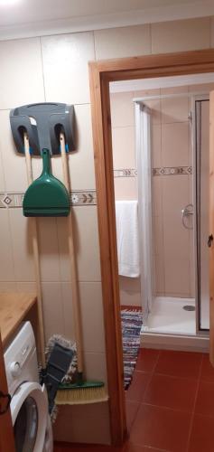 a bathroom with a shower with a light on the wall at Casa da Fonte in Angra do Heroísmo