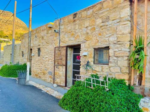 an old stone building with a black door at Dana Tower Hotel in Dana