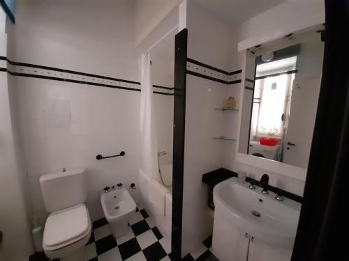 a white bathroom with a toilet and a sink at Appartamento Perla in Beverino