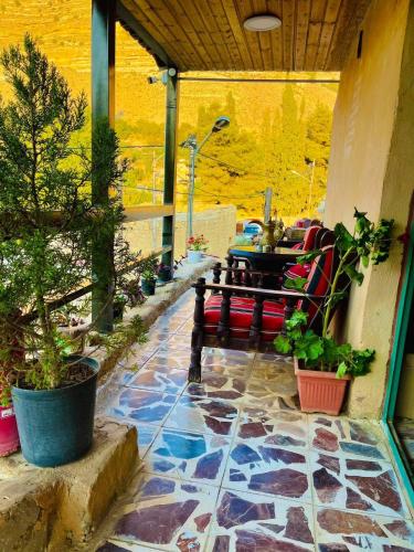 a patio with a table and chairs and plants at Dana Tower Hotel in Dana