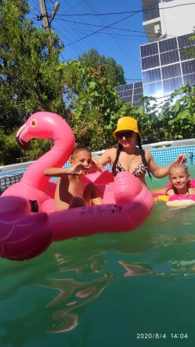 two women and two children in the water on an inflatable at Hotel Lev in Zatoka