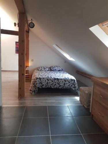 a bedroom with a bed in a attic at Loft dans les Pyrénées in Oloron-Sainte-Marie