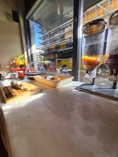 a counter with a glass vase on top of it at Hôtel de la Poste Martigny - City Center in Martigny-Ville