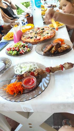 a table with plates of food on it at Hotel Lev in Zatoka