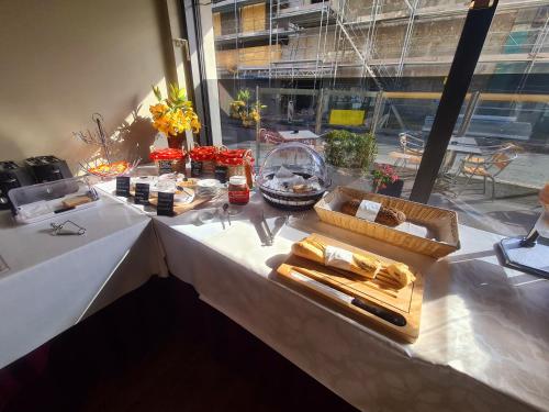 a table with food on top of it at Hôtel de la Poste Martigny - City Center in Martigny-Ville