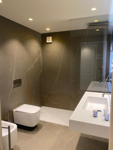 a bathroom with a toilet and a sink and a shower at Duomo Housing Catania Le Suites in Catania